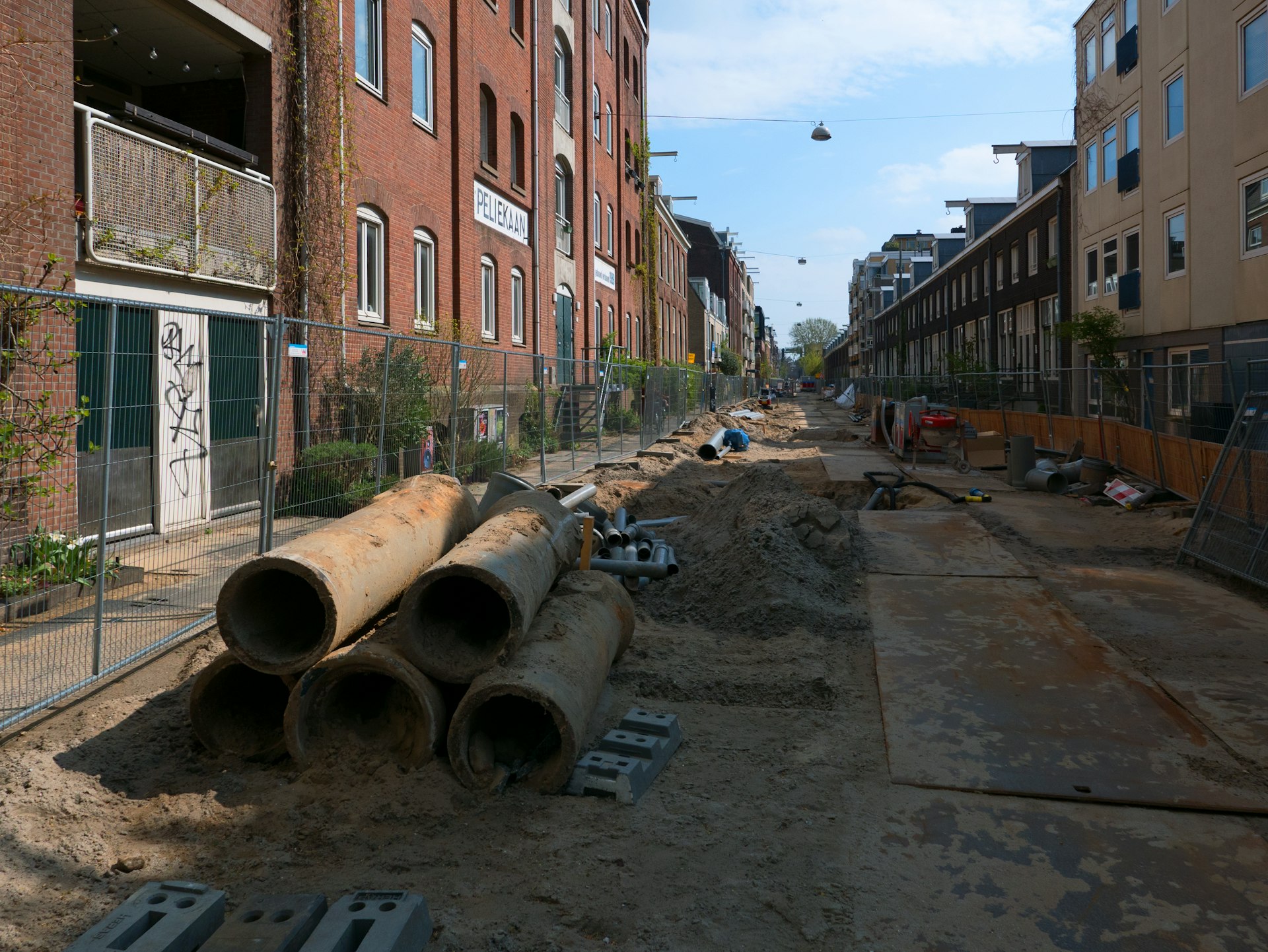 Street construction is underway between old buildings.